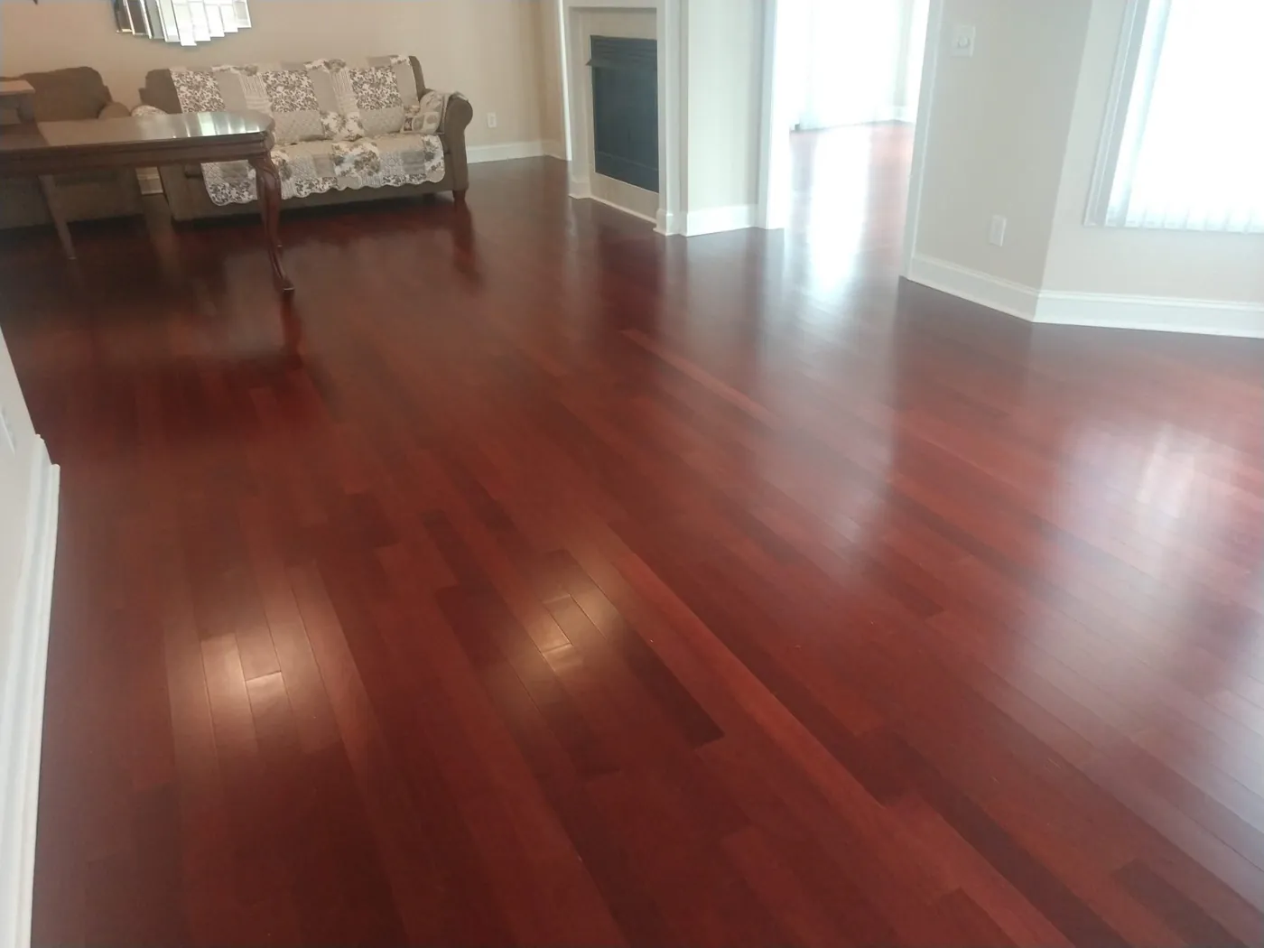 A glossy cherry hardwood floor in a living room.