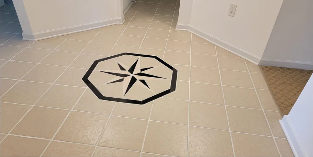 After: the same floor with clean white grout around the compass rose.