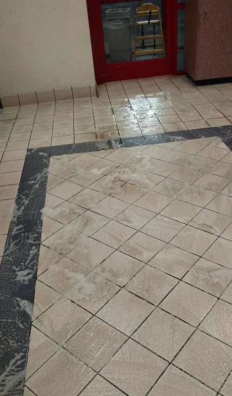 Before: a white tile entry with a dark border, the tile gray with dirt.