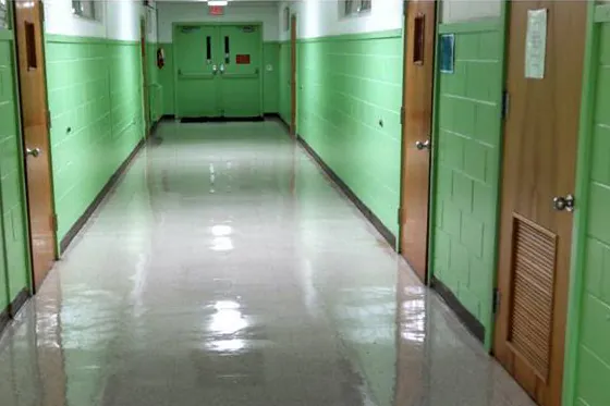 After: the same hallway with the floor clean and glossy.