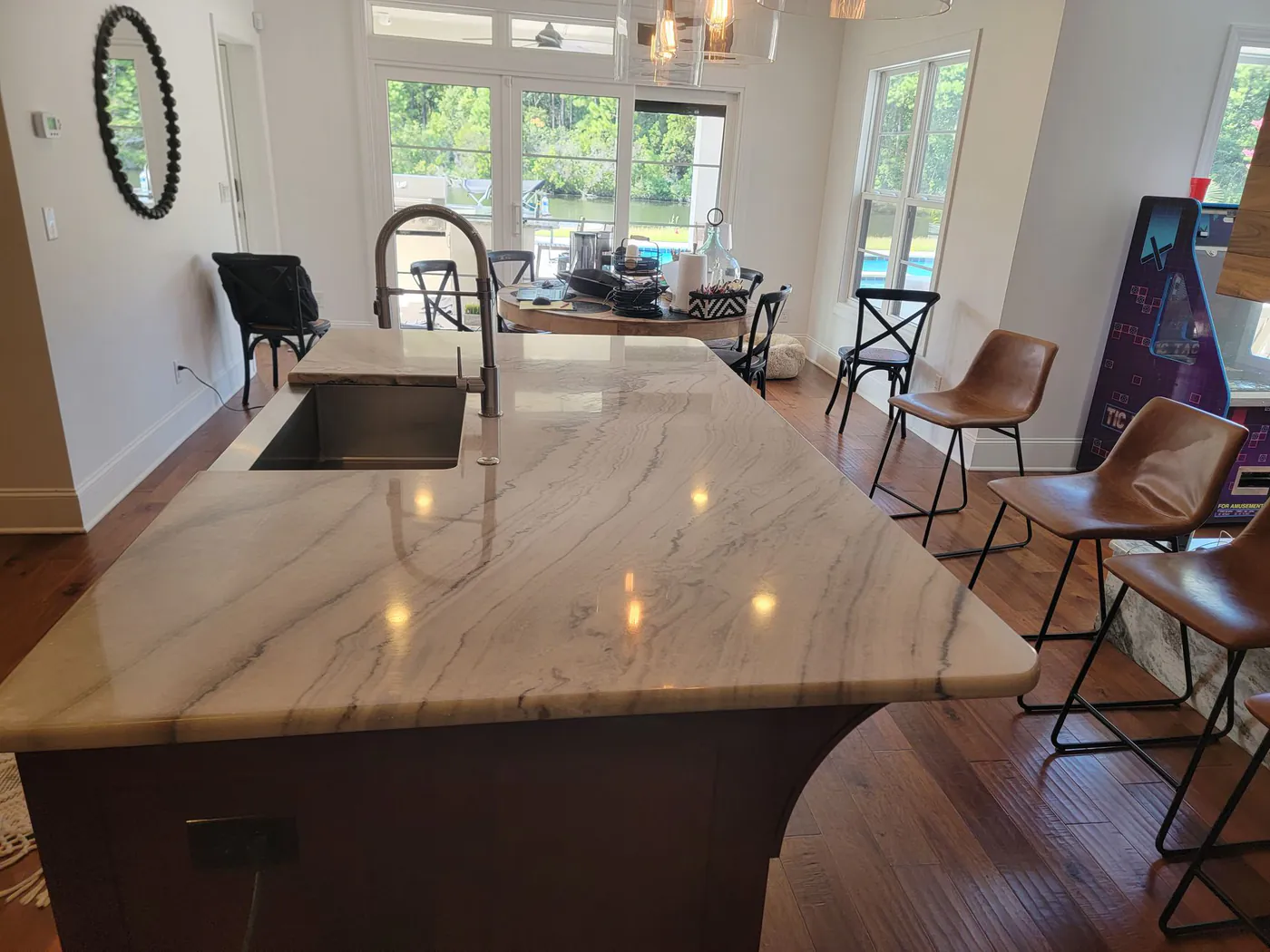 A polished stone kitchen island with a sink.