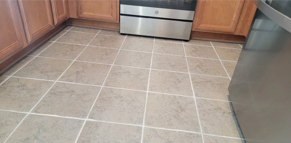 After: the same kitchen floor with clean, light grout.