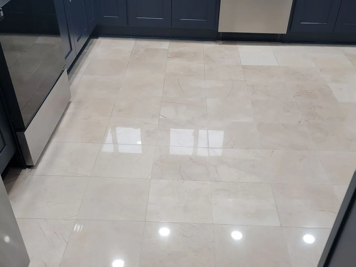 After: the same floor polished, reflecting the ceiling lights like glass.