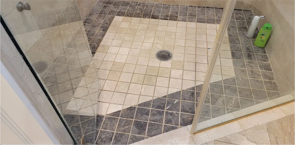 After: the same marble shower floor cleaned.