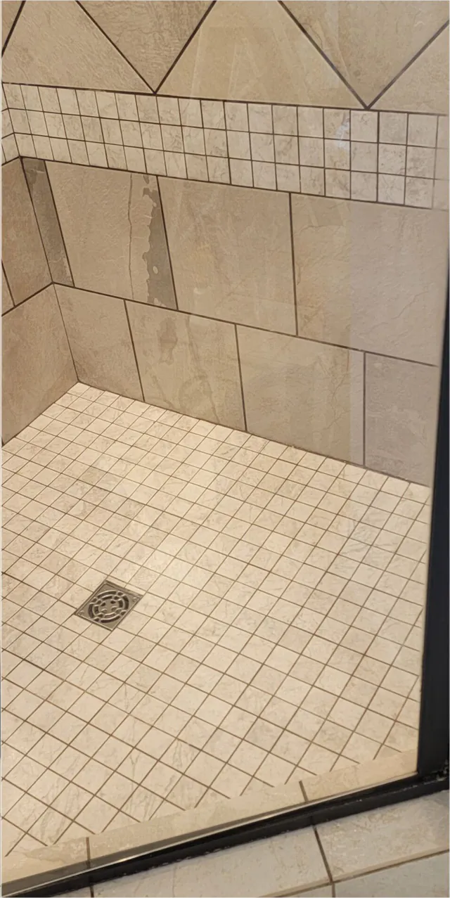 After: the same shower corner with clean grout.