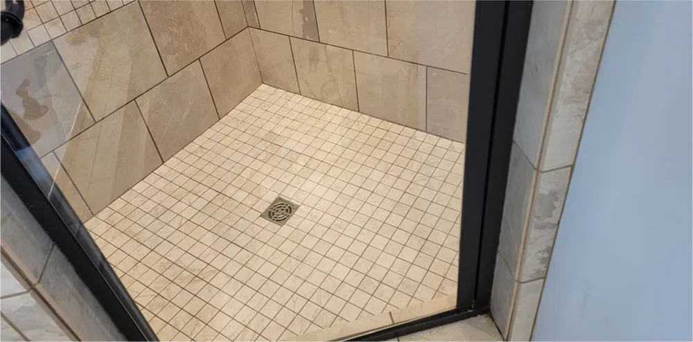 After: the same shower with the tile and grout clean.
