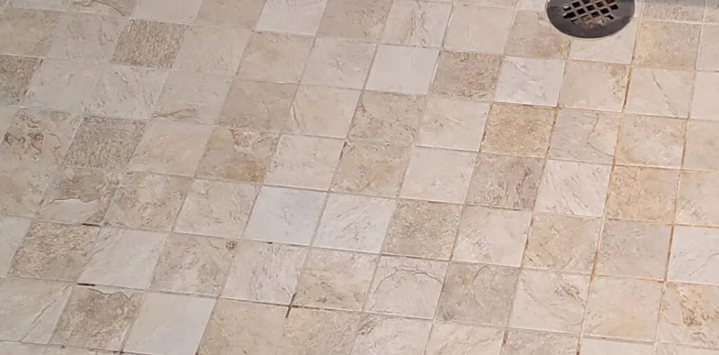 After: the same shower floor, clean and even in color.