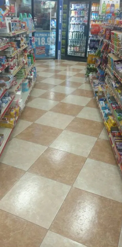 After: the same aisle with the floor clean and glossy.